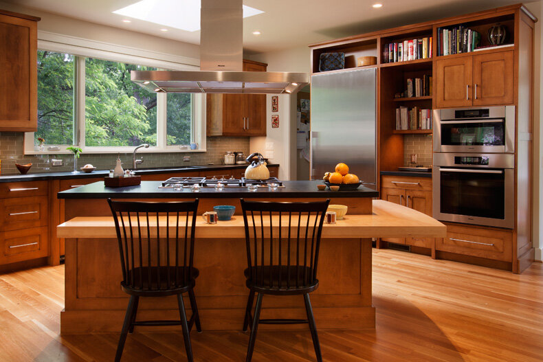 Wood kitchen cabinets with island and built-in shelving